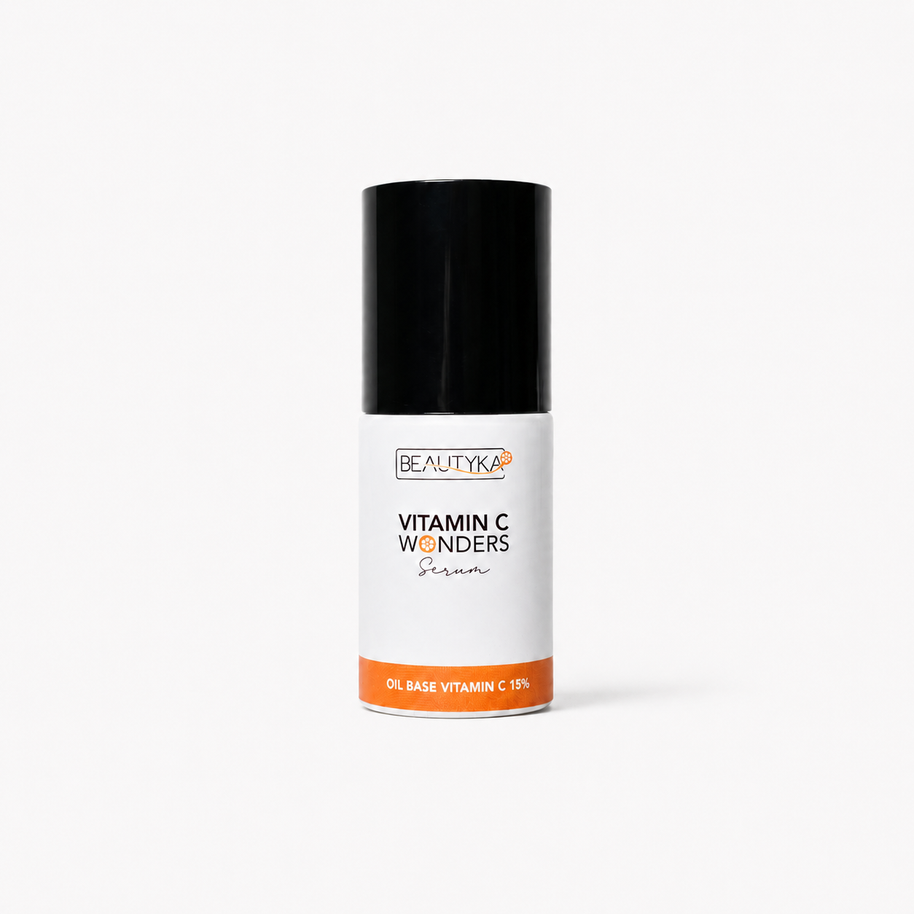 A bottle of Beautyka Vitamin C Wonders Oil Serum with an orange band and black cap on a clean white background.