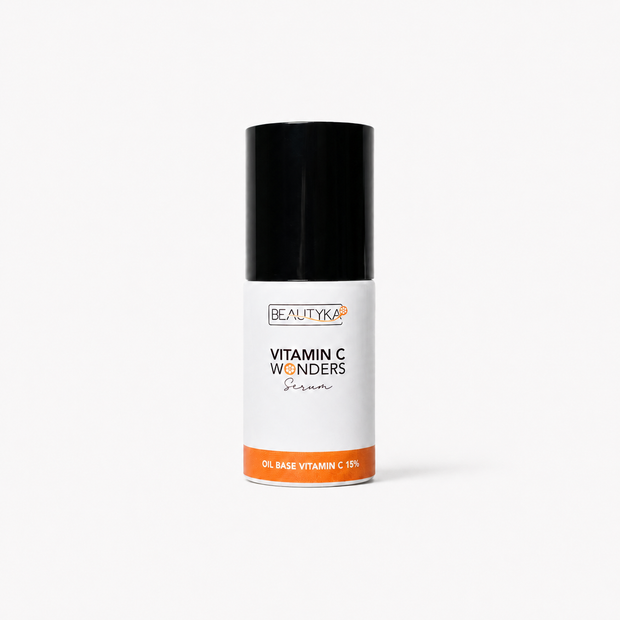 A bottle of Beautyka Vitamin C Wonders Oil Serum with an orange band and black cap on a clean white background.