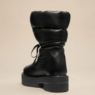 Chunky black puffer boot with thick sole and lace-up detail on neutral background