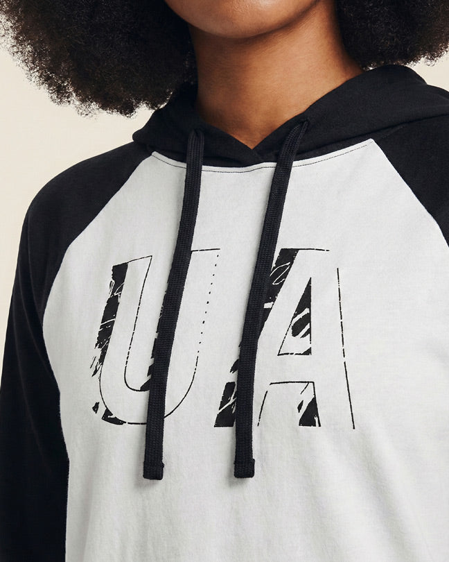 Close-up of woman wearing black and white UA graphic hoodie with drawstrings