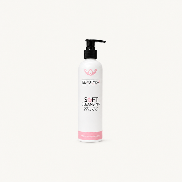 A white bottle of Beautyka Soft Cleansing Milk with a black pump and pink accents on an off-white background.