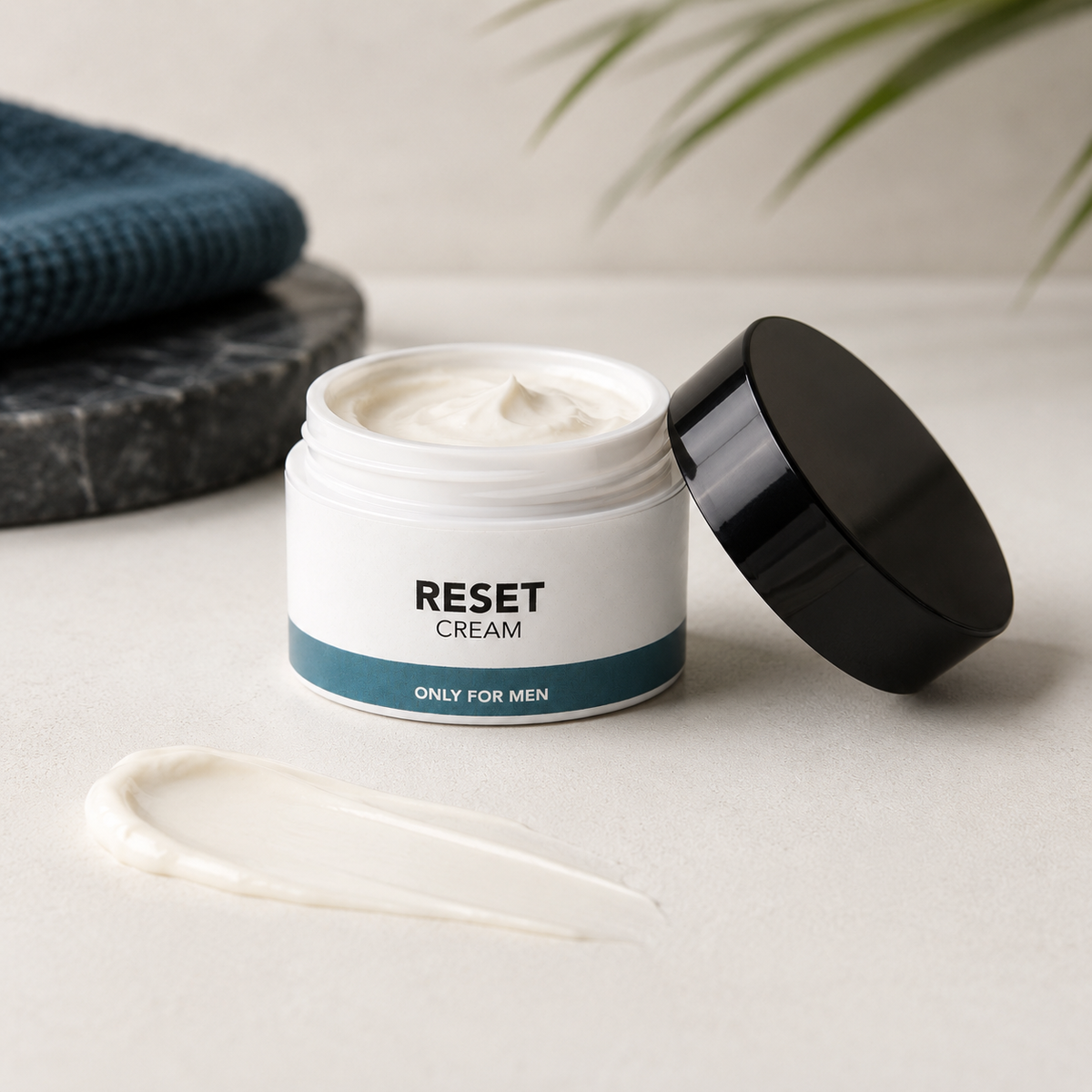 A jar of Reset Cream with its black lid off, showing the white cream inside, with a smear of the cream in front on a light beige surface.