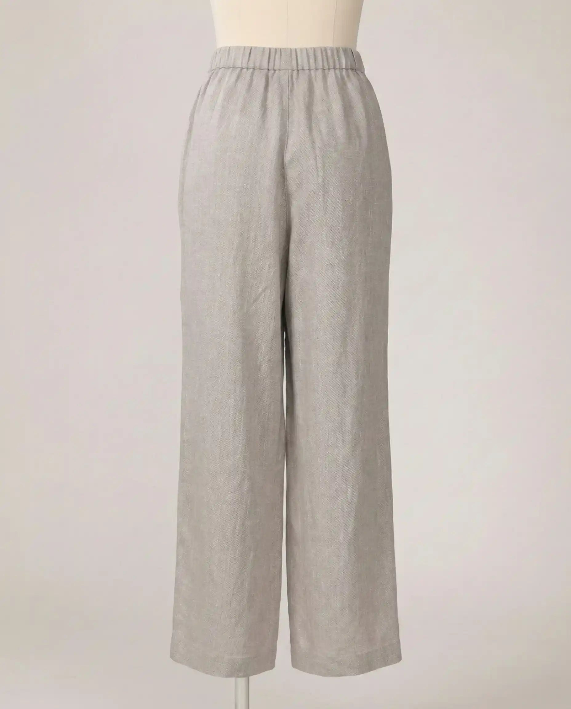 Light grey wide-leg linen pants with elastic waistband on a mannequin