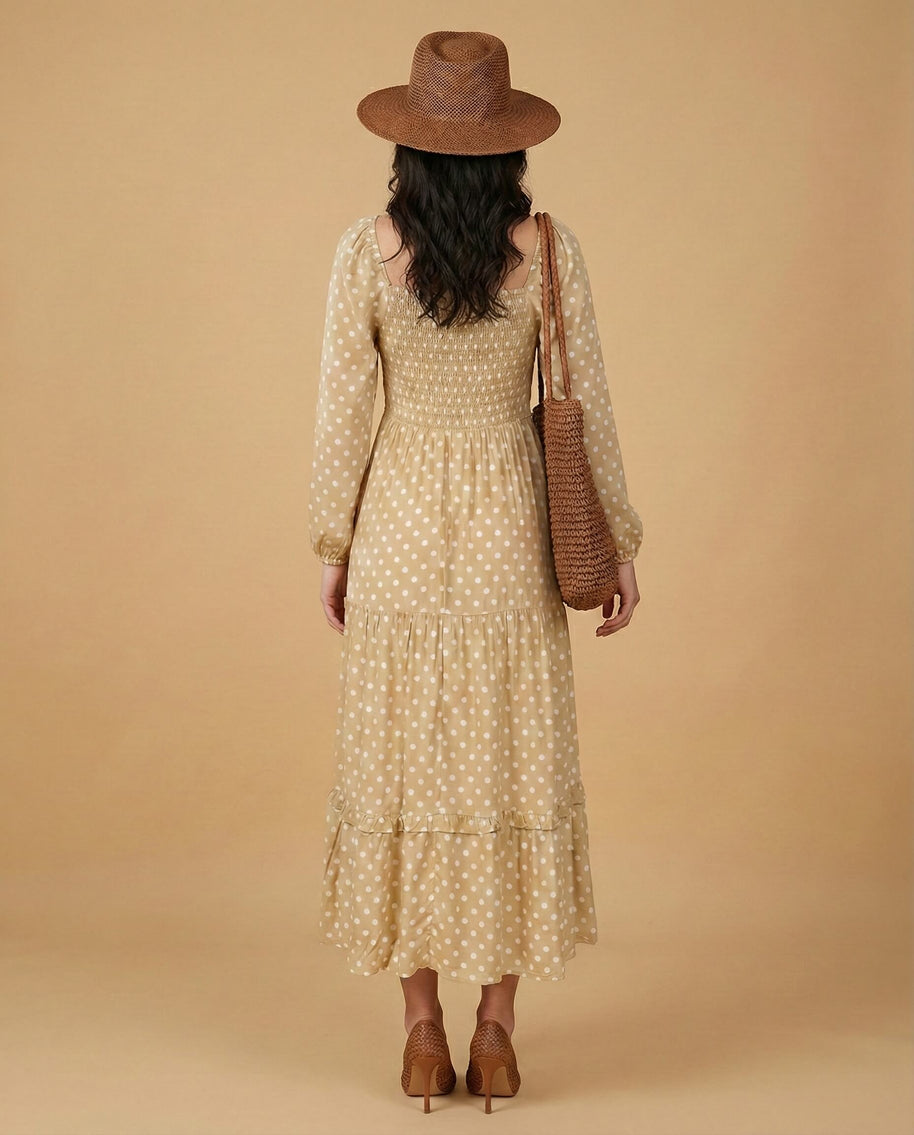 Woman in beige polka dot midi dress, straw hat, woven bag, heels, neutral background