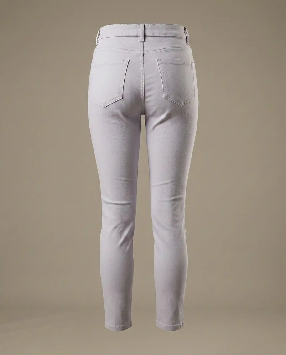 Back view of light gray skinny jeans with two pockets on a neutral background