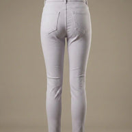 Back view of light gray skinny jeans with two pockets on a neutral background