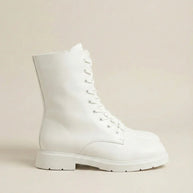 White lace-up combat boot with chunky sole on neutral background