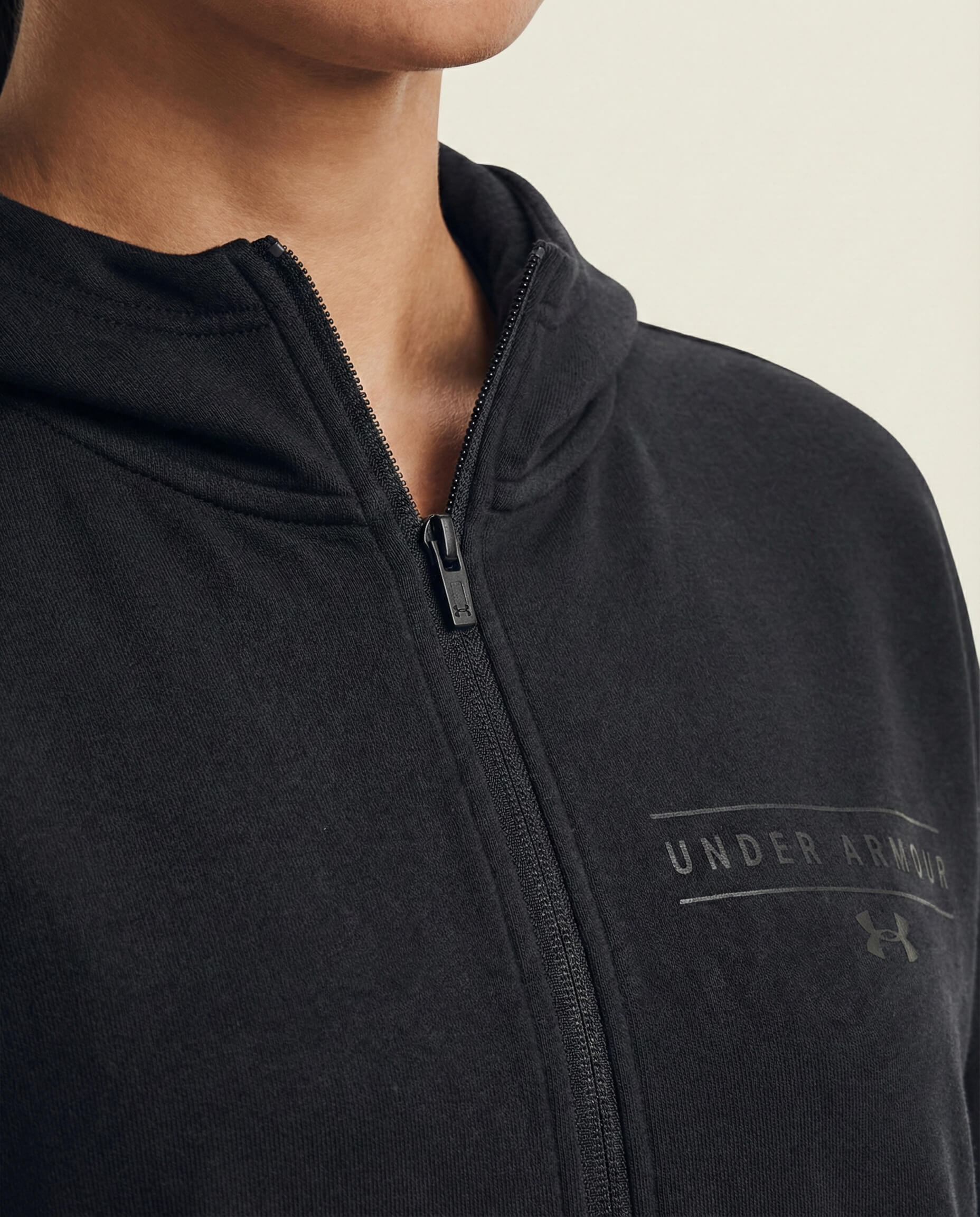 Black Under Armour zip-up hoodie close-up, sportswear, minimal design, front zipper