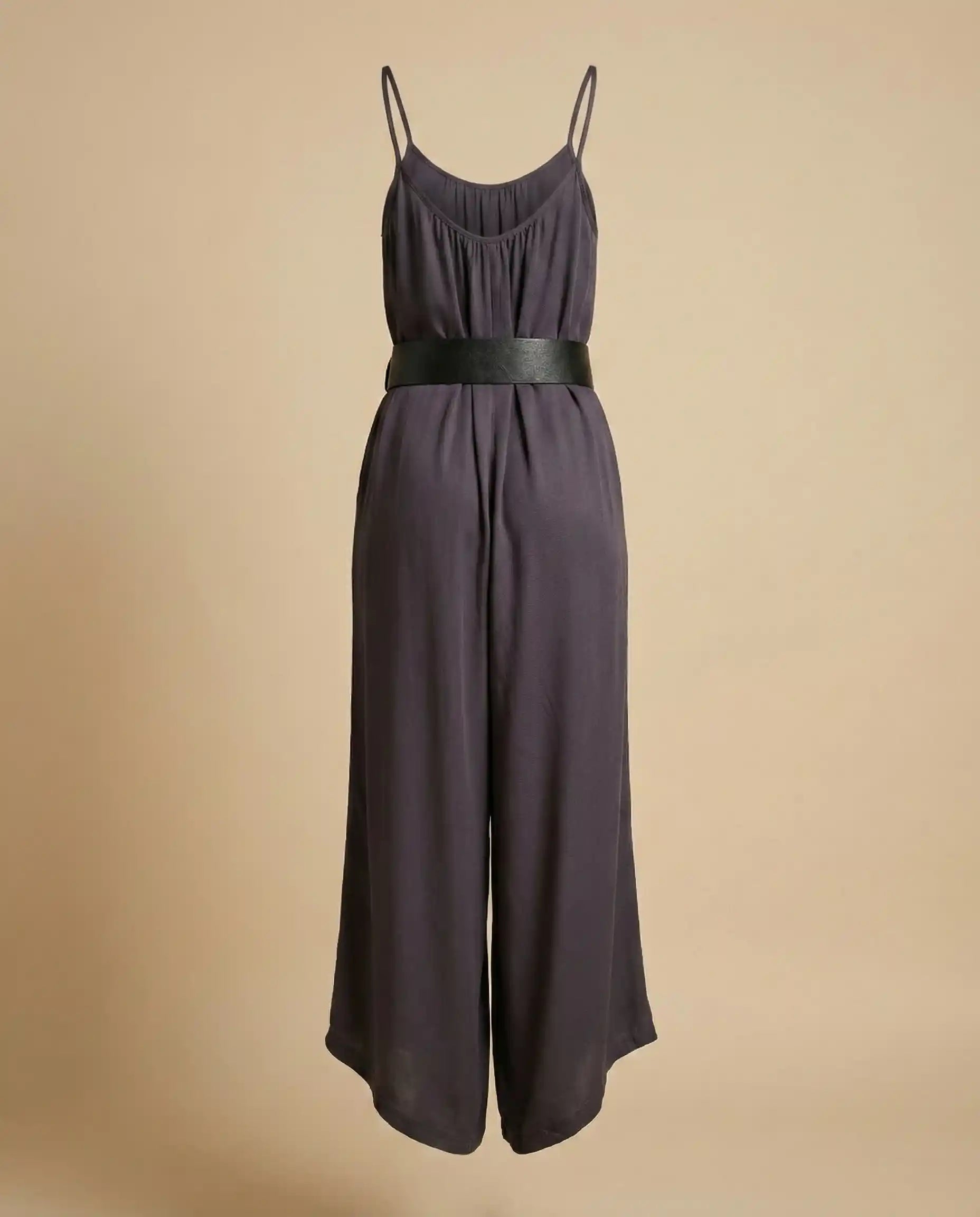 Sleeveless black jumpsuit with wide leg pants, thin straps, and wide black belt