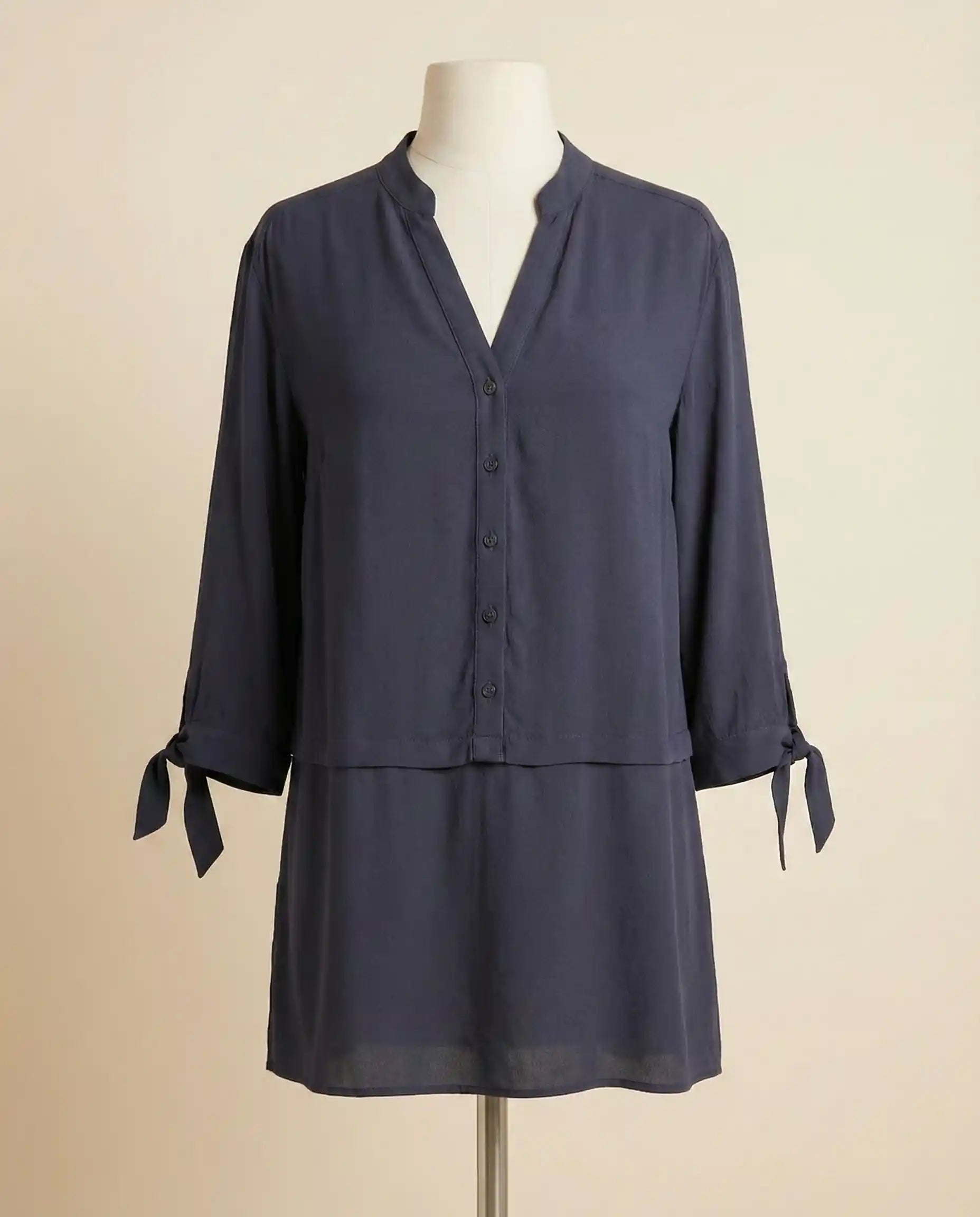 Navy blue tunic blouse with V-neck, button front, 3/4 sleeves, and tie cuffs