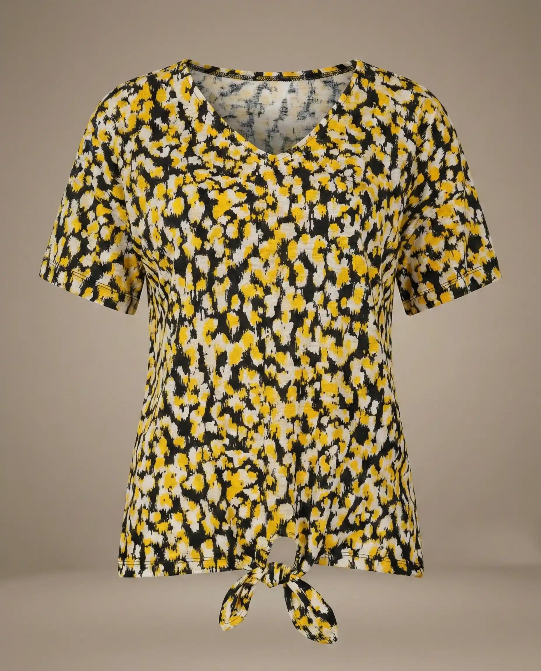 Yellow and black abstract print short sleeve V-neck tie-front blouse on plain background
