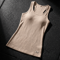Beige athletic tank top with racerback design on textured black surface