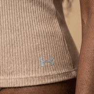 Close-up of beige ribbed Under Armour shirt on person's waist, athletic wear focus