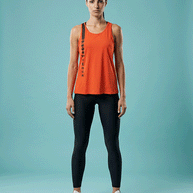 Woman wearing red Under Armour sleeveless workout top and black leggings, standing front view