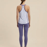Woman in light blue athletic tank top, purple leggings, and running shoes, shown from behind