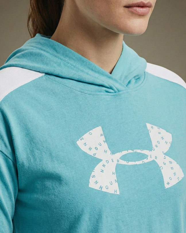 Light blue hooded sweatshirt with white logo detail on chest, worn by a woman