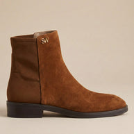 Brown suede ankle boot with low heel and gold SW logo on plain background