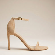Beige suede high heel sandal with ankle strap and open toe on a neutral background