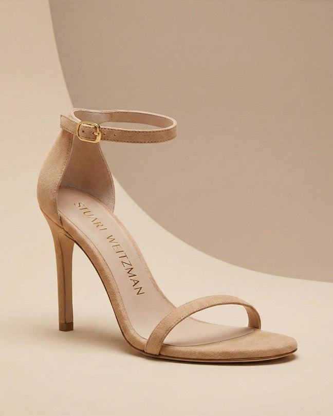 Beige suede high heel sandal with ankle strap and open toe on neutral background