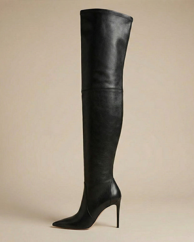 Black over-the-knee leather stiletto boot with pointed toe on neutral background