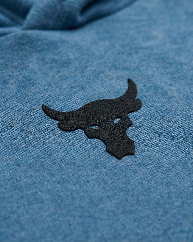 Black bull head logo on blue heathered fabric, close-up of textured clothing design.