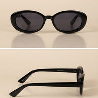 Black oval sunglasses with dark lenses, glossy finish, shown front and side view on beige background