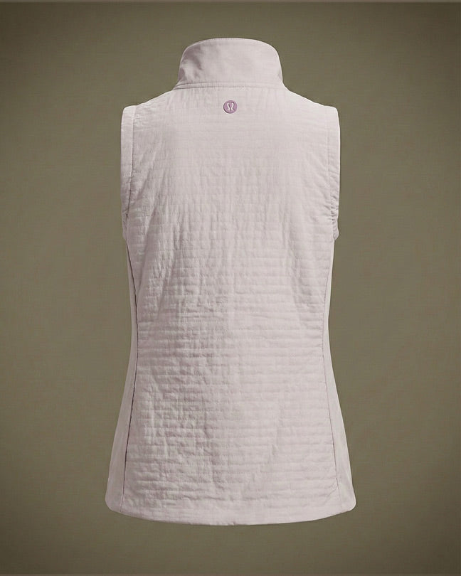 Light pink quilted sleeveless vest with high collar, viewed from the back