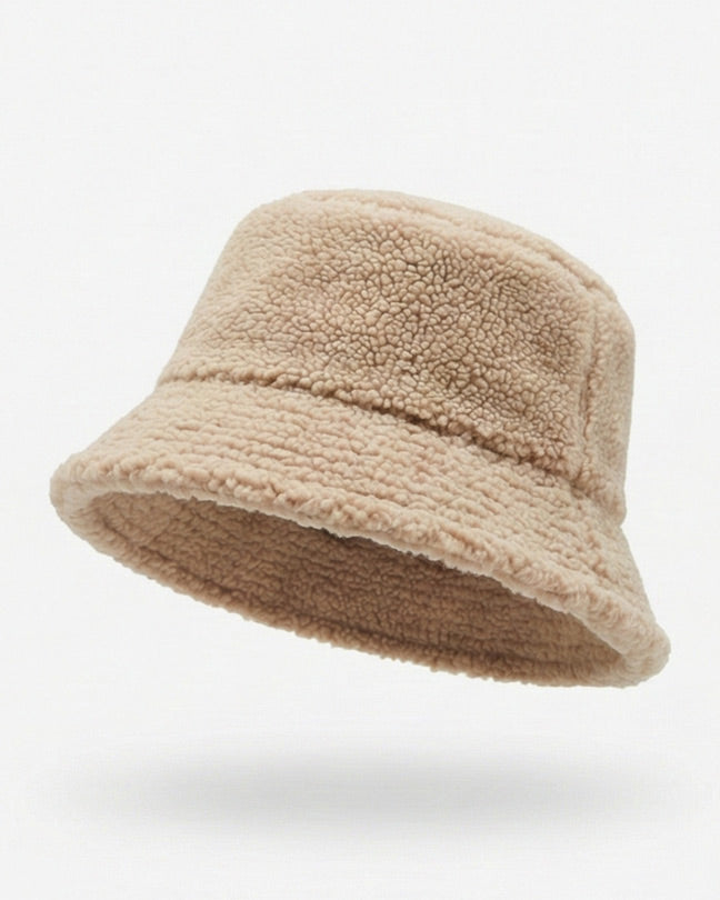Beige fleece bucket hat with textured sherpa fabric on a plain white background