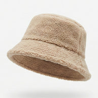 Beige fleece bucket hat with textured sherpa fabric on a plain white background