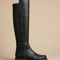 Black knee-high boot with woven leather texture and stretch fabric panel